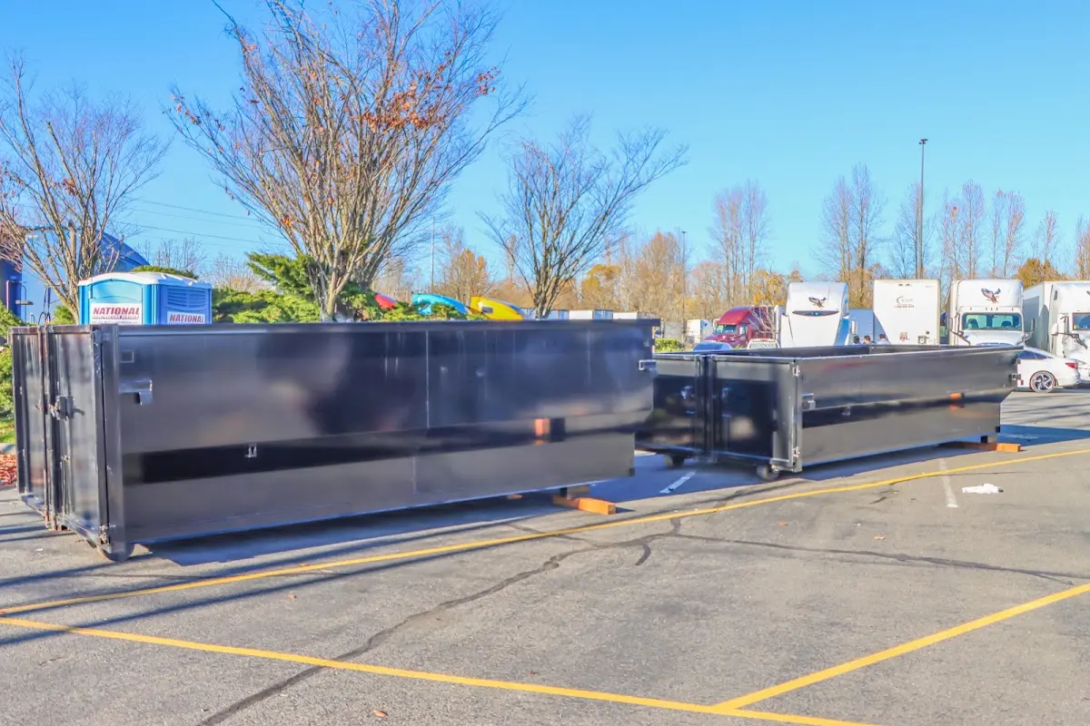 Professional dumpster rental service with roll-off container on residential driveway in Fitchburg